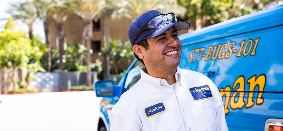 bugman exterminator next to a truck
